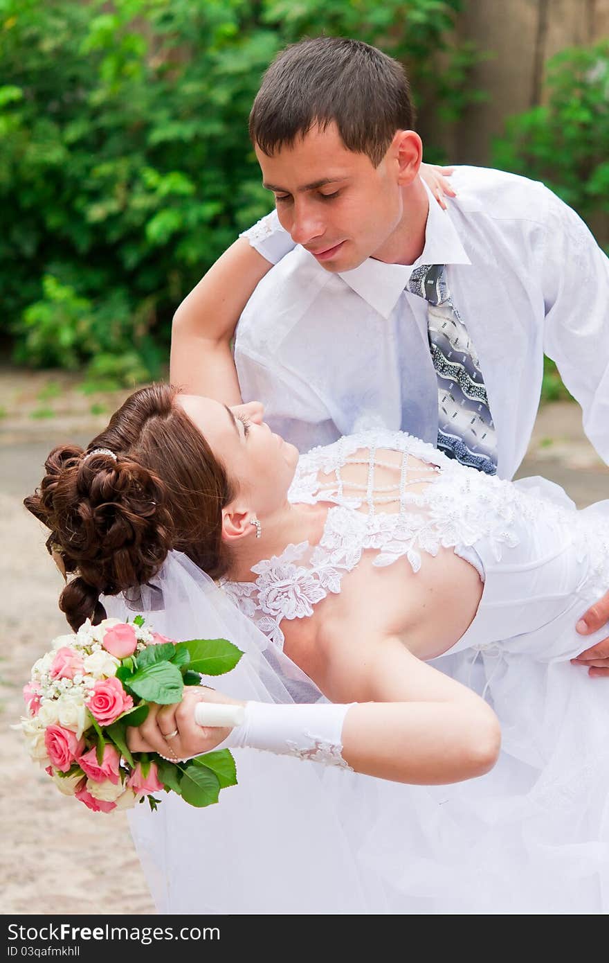 Bride and groom dancing outdoor