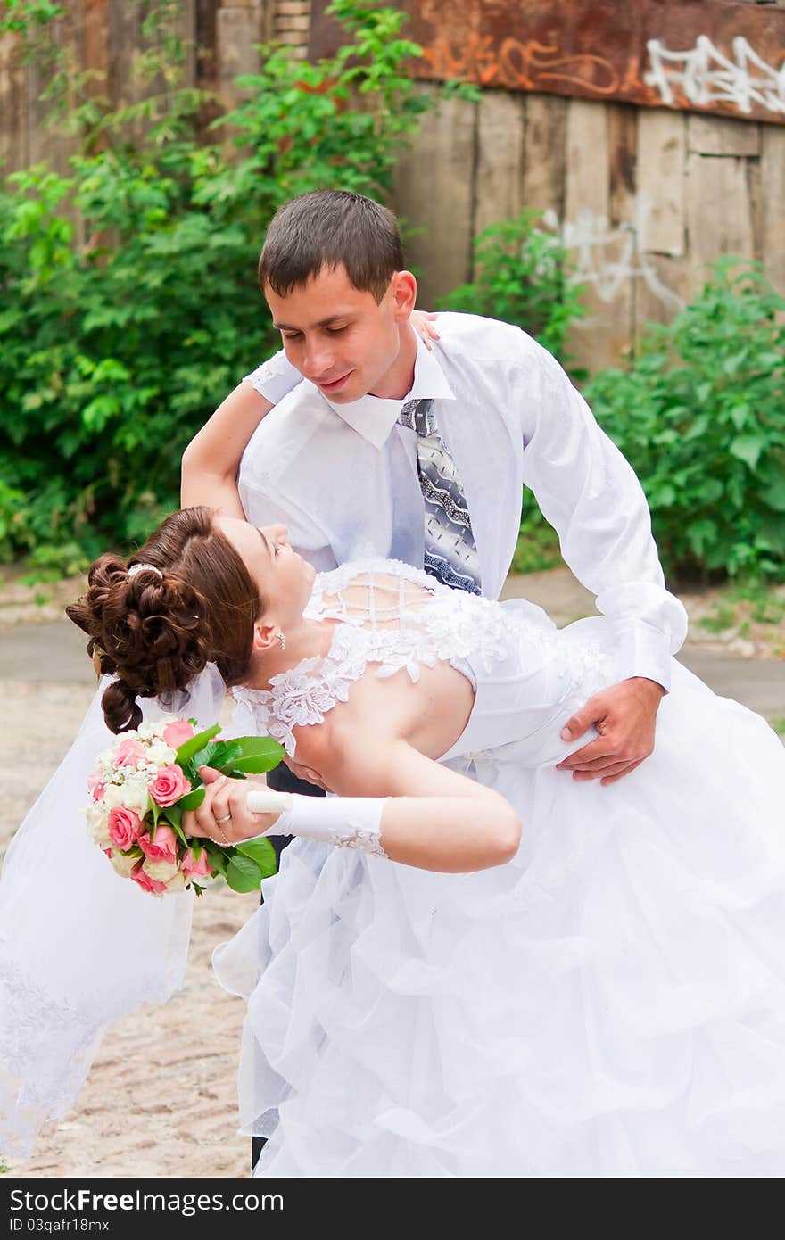 Bride and groom dancing outdoor