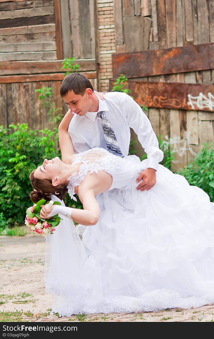 Bride and groom dancing outdoor