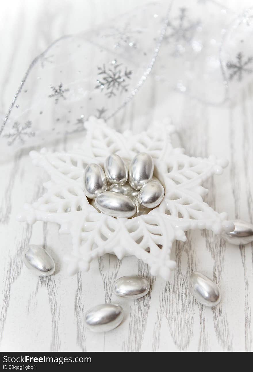 Silver Pistachio Candy on the white wooden background