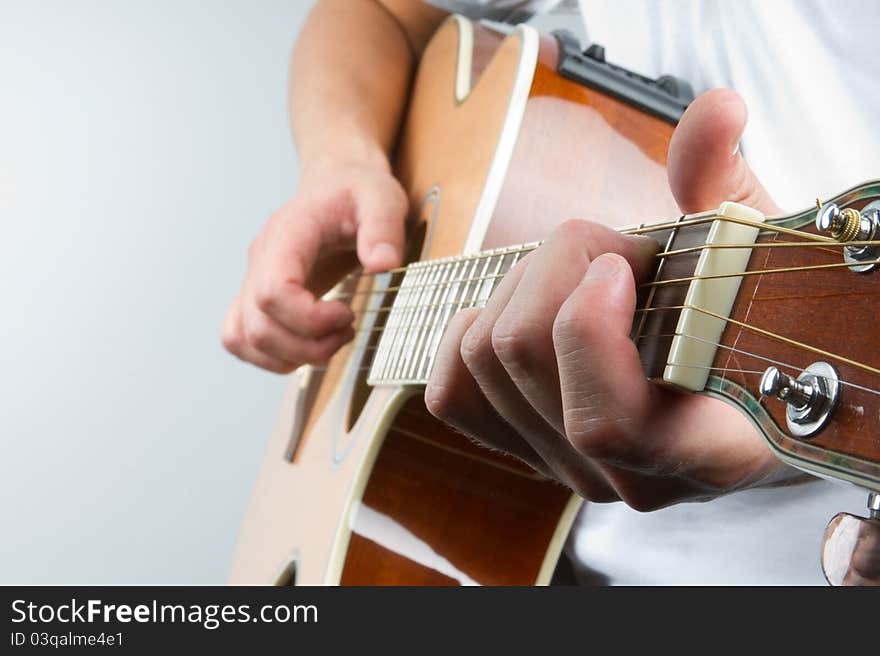 A part of musician body playing acoustic guitar. A part of musician body playing acoustic guitar