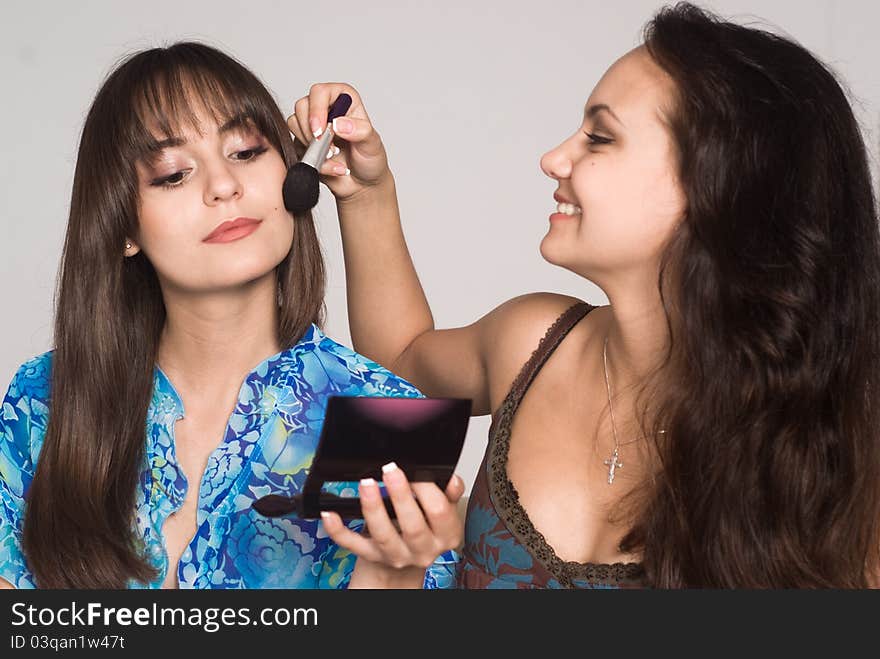 Portrait of a two girls making up