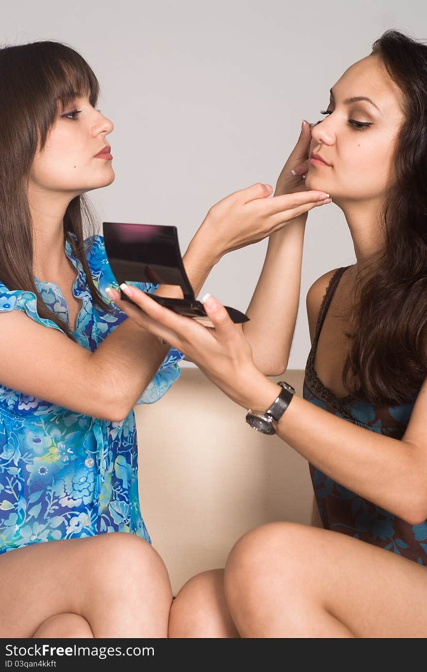 Portrait of a two girls making up