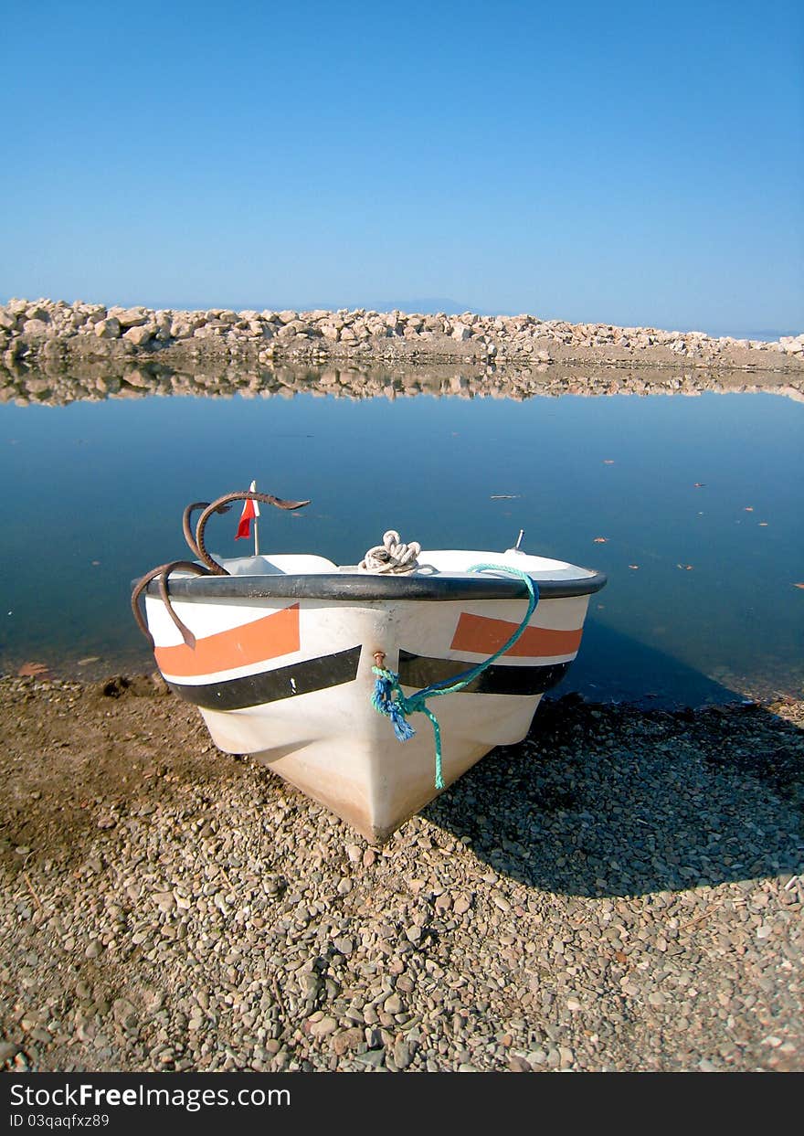 Old fish-boat on sand beach.