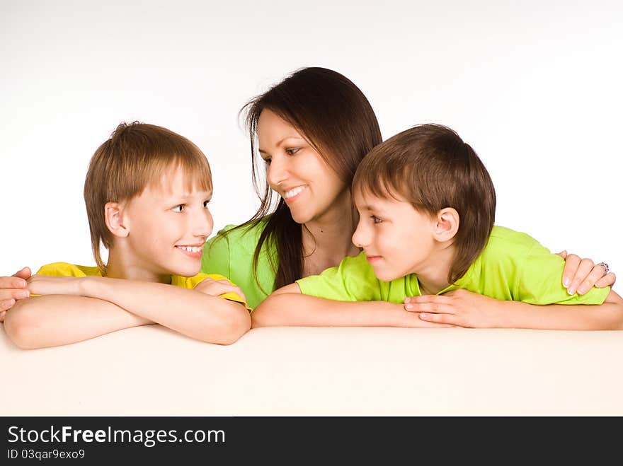 Cute mom with her little boys on sofa. Cute mom with her little boys on sofa