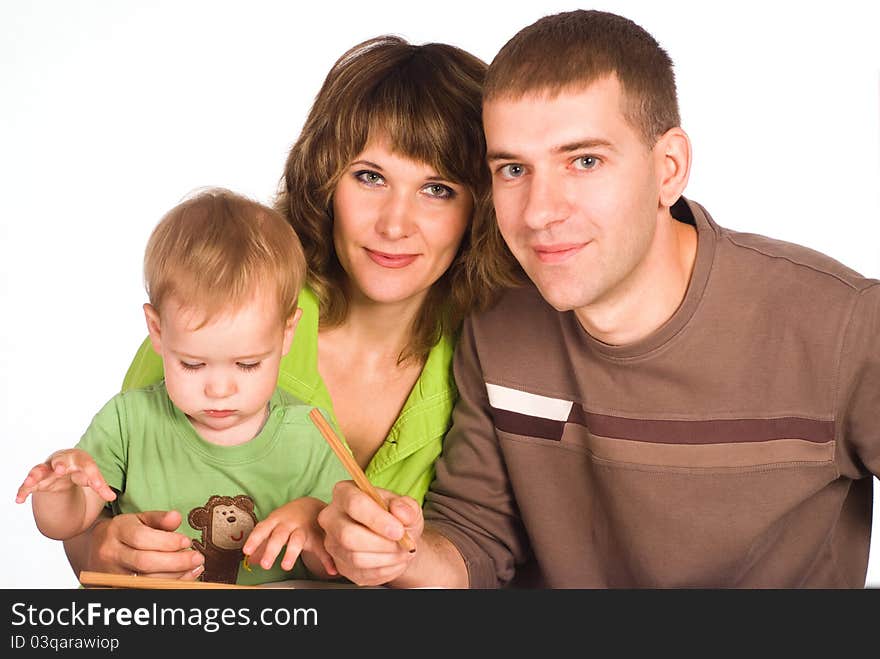 Portrait of a cute family drawing at table