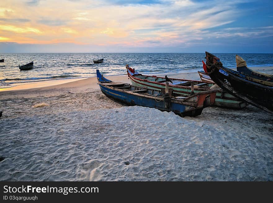 The old fishing boats on the sandy shore. The old fishing boats on the sandy shore