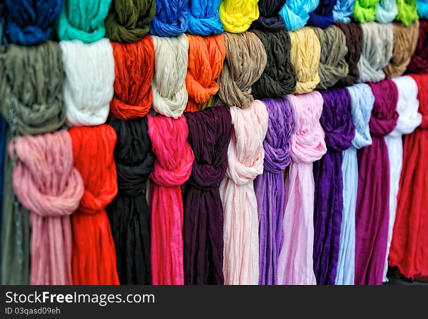 The colored silk scarfs in rows in market