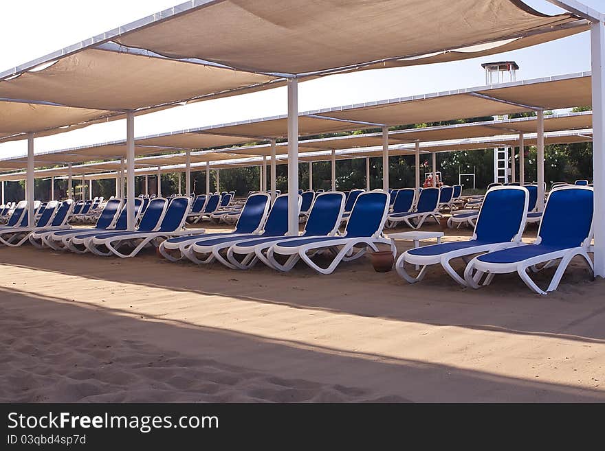 Many loungers on the beach.