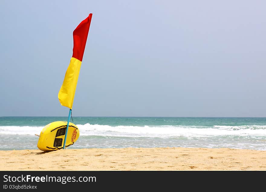 Surf Rescue surfboard and flags on Naiharn beach, Phuket Thailand