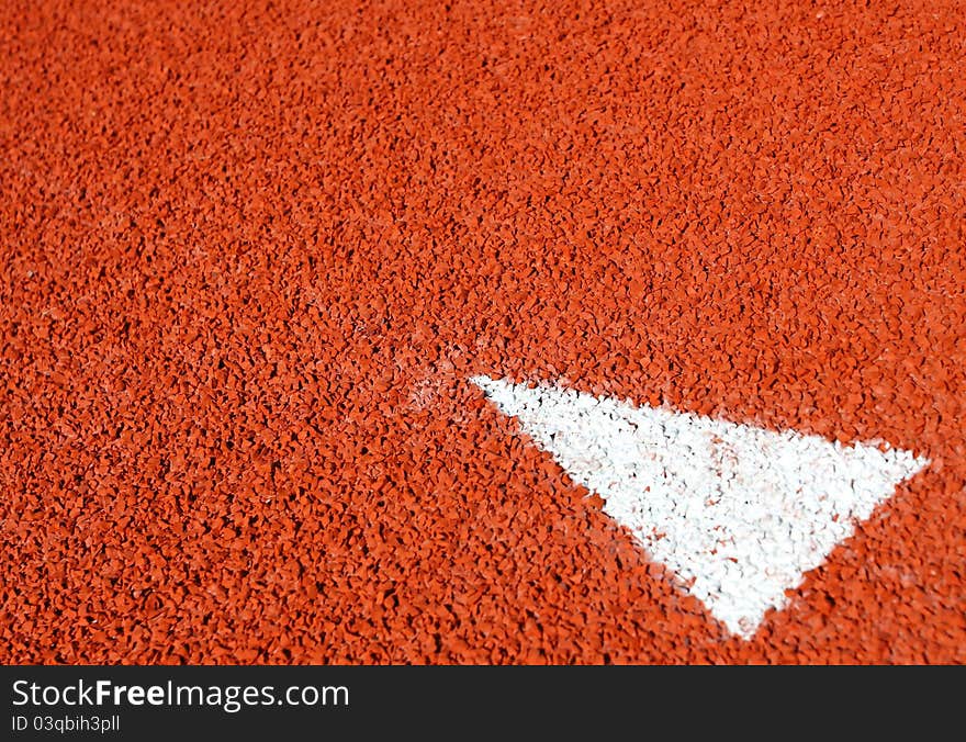 A Arrow Sign On Running Track