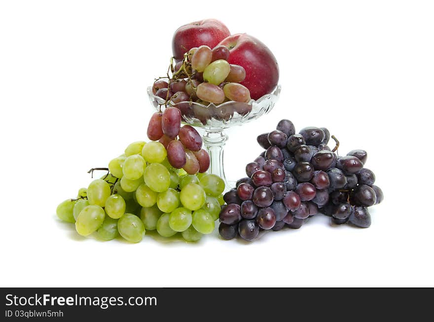 Fruits in glass vase on white background