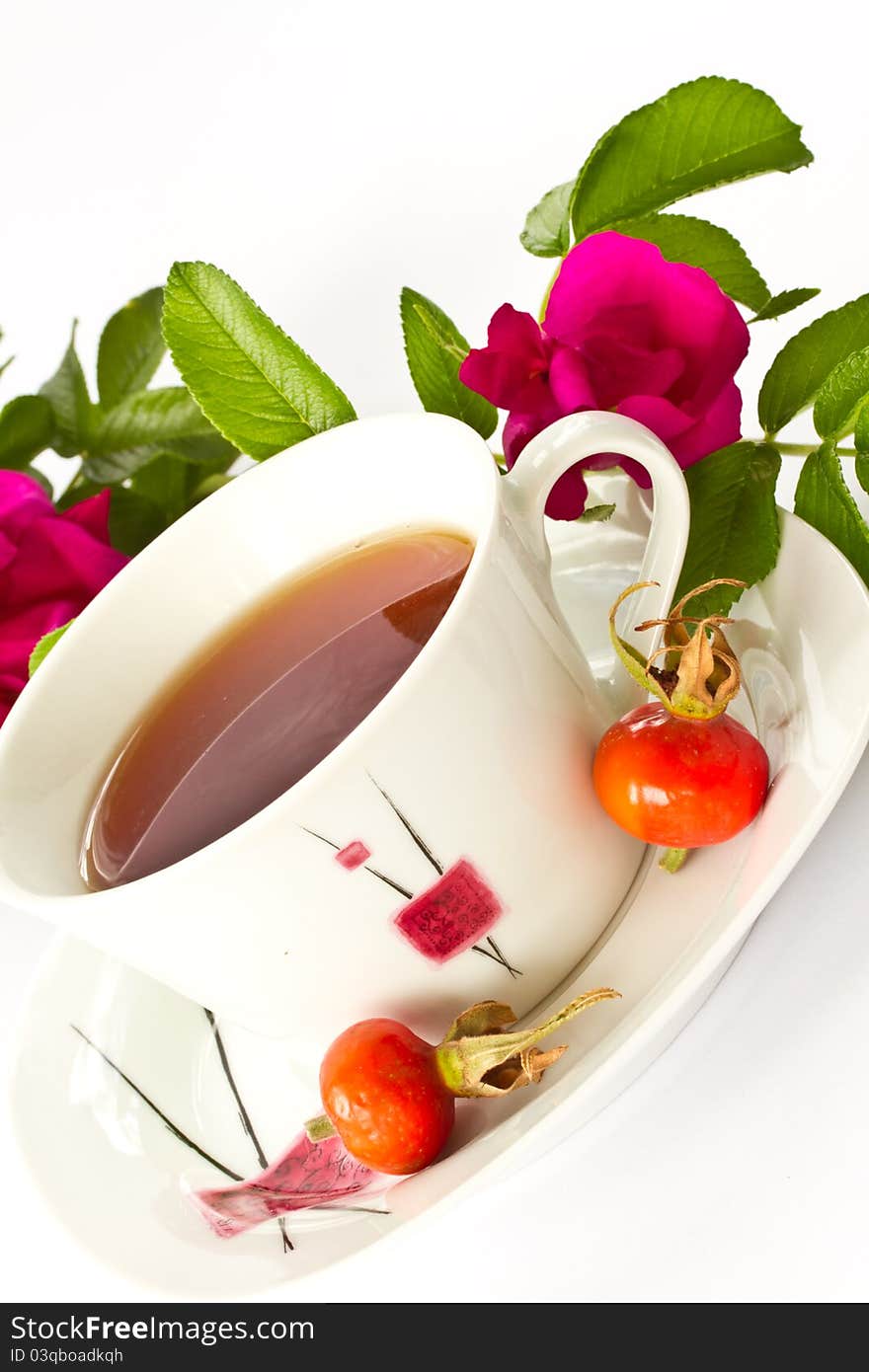 Rosehip tea on the background of fruits and flowers. Rosehip tea on the background of fruits and flowers