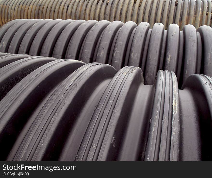 Rows of pvc drainage pipes lined up on the construction site