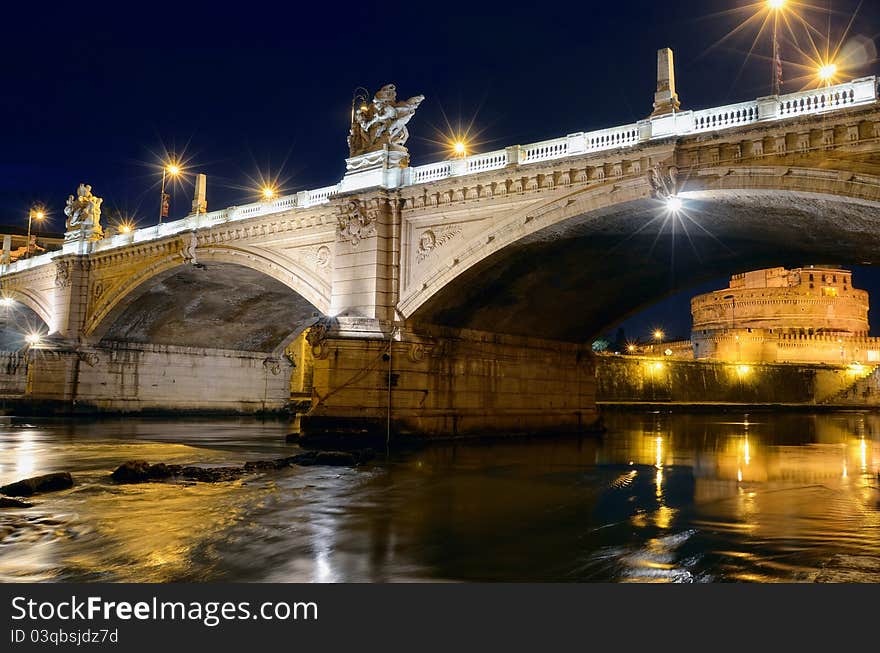 Bridge crossing the river Tiber and Castle Sant'Angelo illuminated at night. Bridge crossing the river Tiber and Castle Sant'Angelo illuminated at night