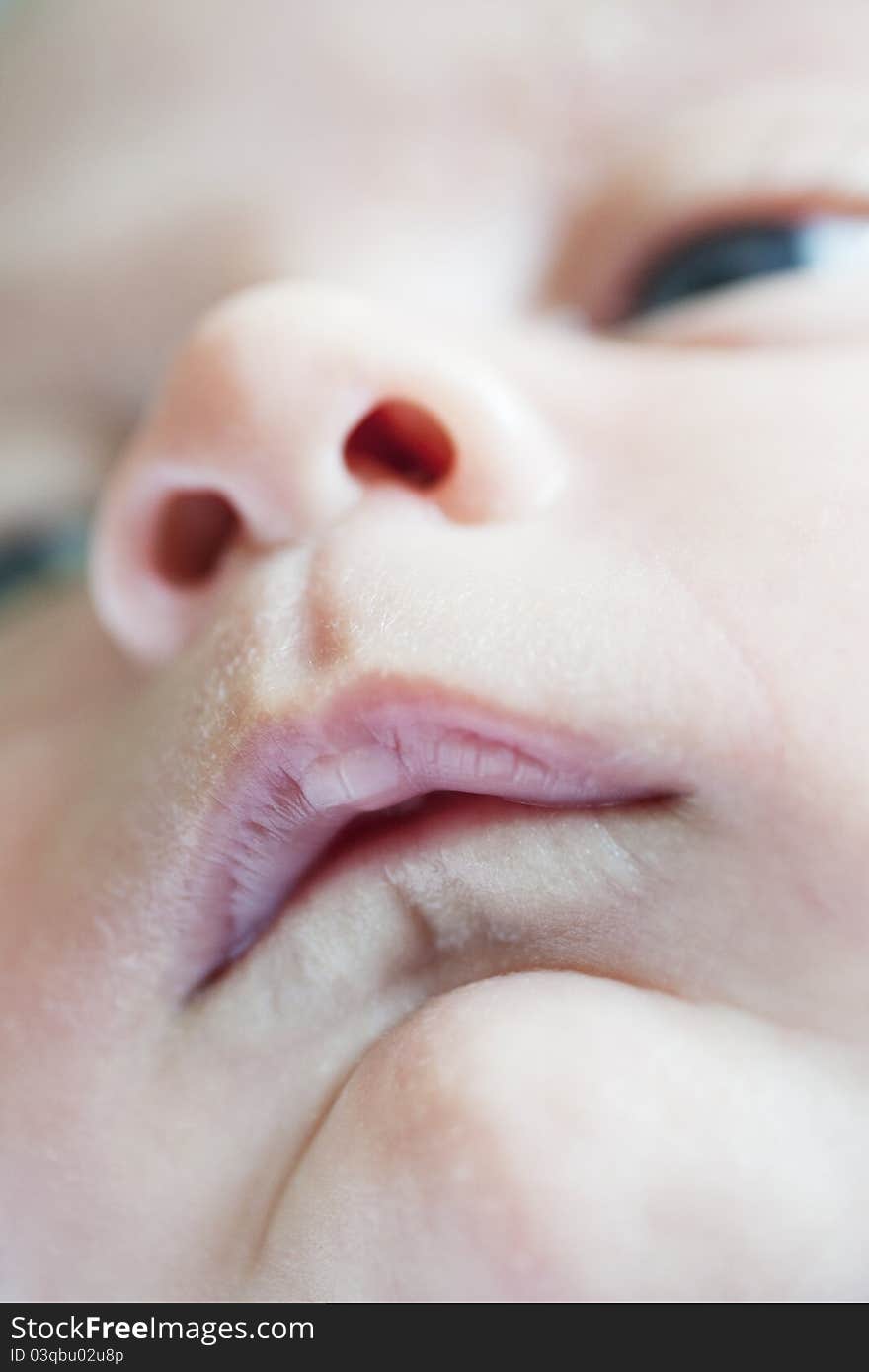 Small mouth of a newborn and nouse and eyes out of focus