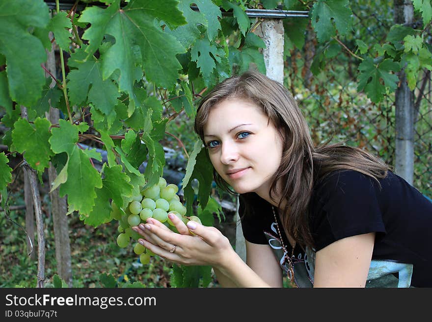 Girl with a bunch of grapes in hand. Girl with a bunch of grapes in hand