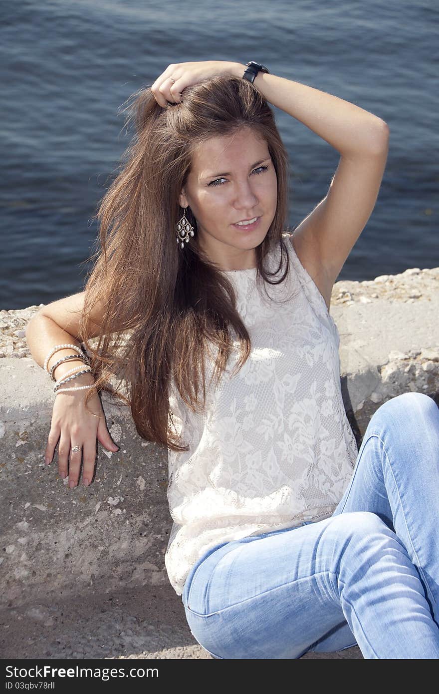 Young brunette on the river background