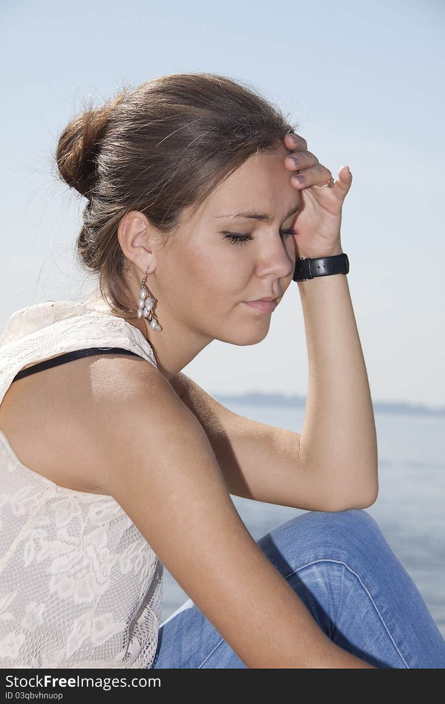 Young brunette on the river background