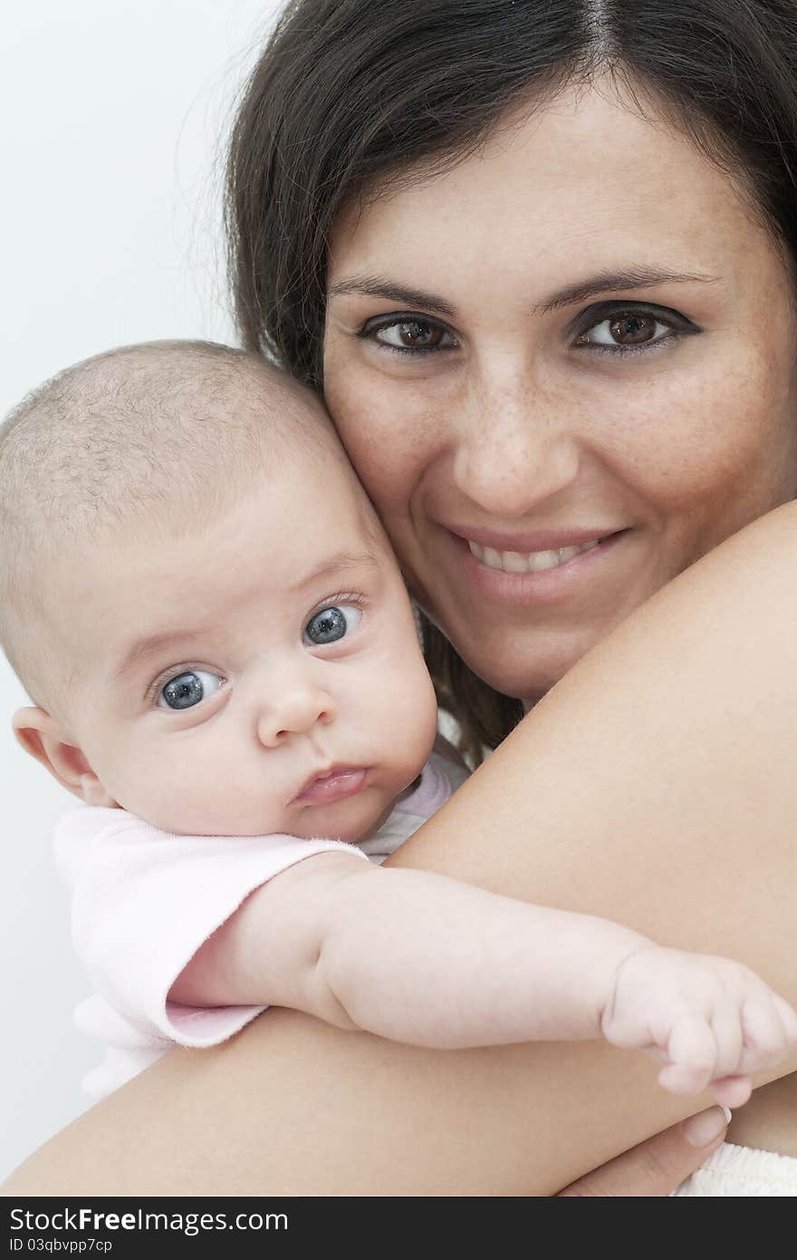 Happy newborn with blue eyes in his mother's arms and smiling mom. Happy newborn with blue eyes in his mother's arms and smiling mom