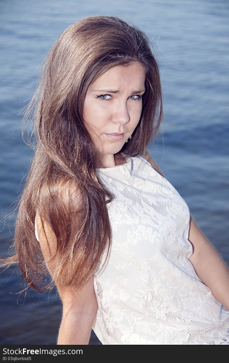 Young brunette on the river background