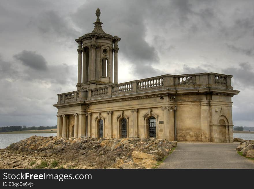 Ancient Normanton chapel on shores of a lake in the uk