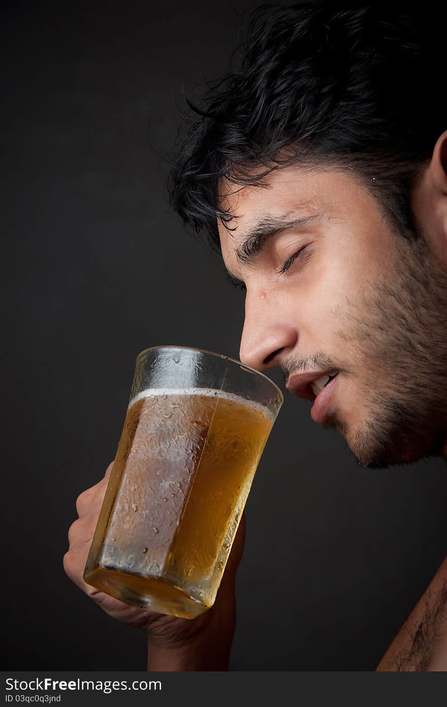 Indian Man drinking beer  from beer mug