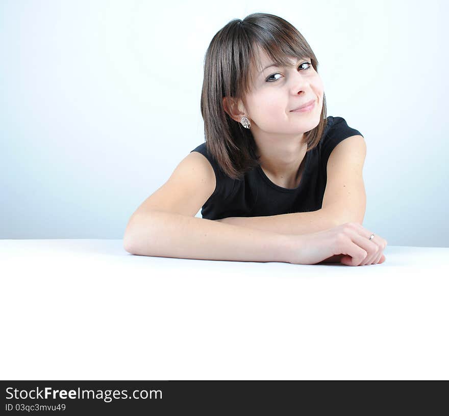 Young woman leaning on a table