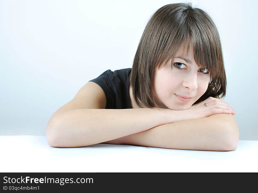 Young woman leaning on a table