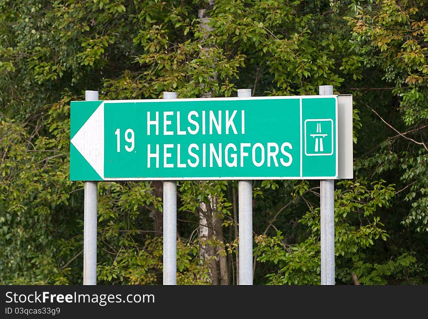 Road sign with 19 kilometers to Helsinki. Text in sign both Finnish and Swedish. Road sign with 19 kilometers to Helsinki. Text in sign both Finnish and Swedish.