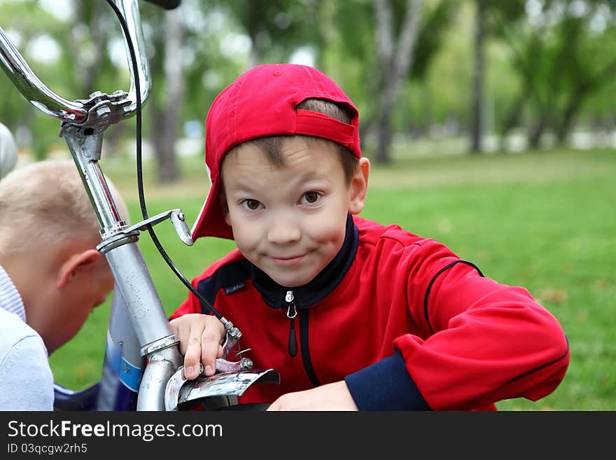 Boy on a bicycle in the green park