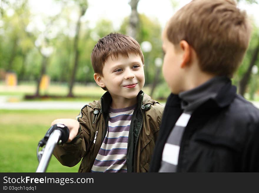 Happy smiling boy on a bicycle in the green park