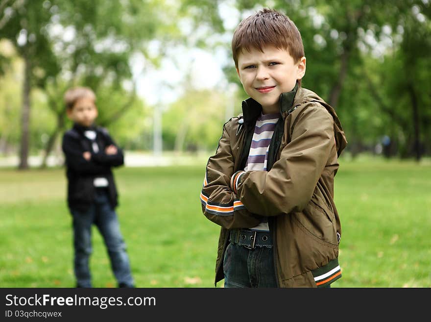 Happy smiling boy with a friend in the green park