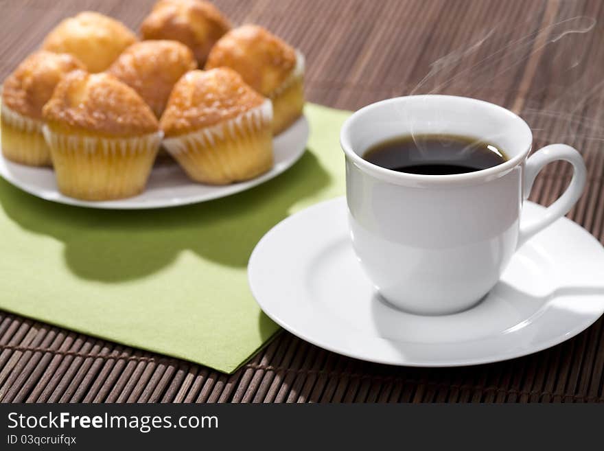 A breakfast with a cup of hot coffee and muffins!. A breakfast with a cup of hot coffee and muffins!