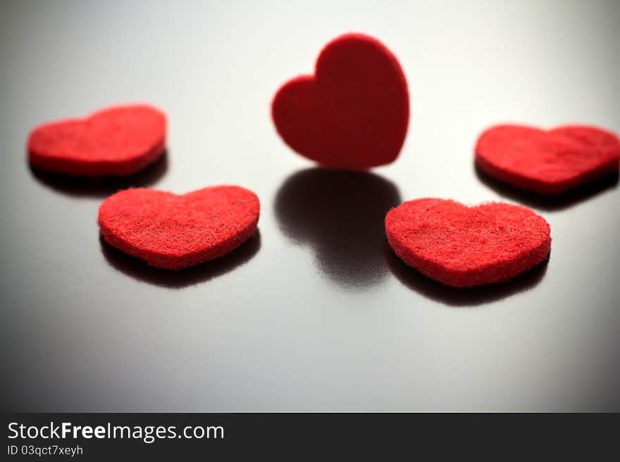 Five red hearts on a gray background. Five red hearts on a gray background.