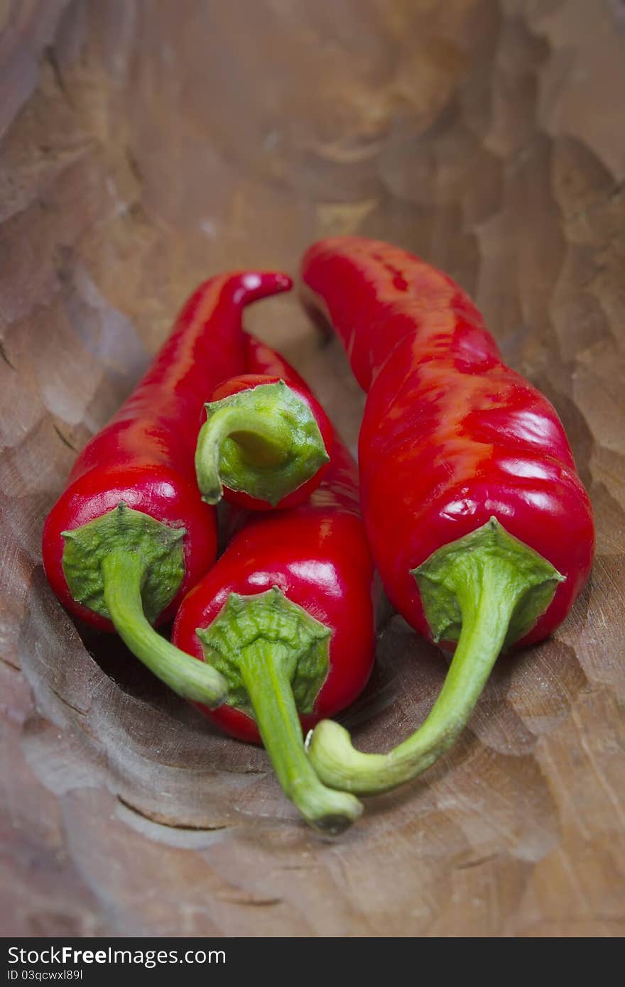 Red hot chili peppers on old wooden background