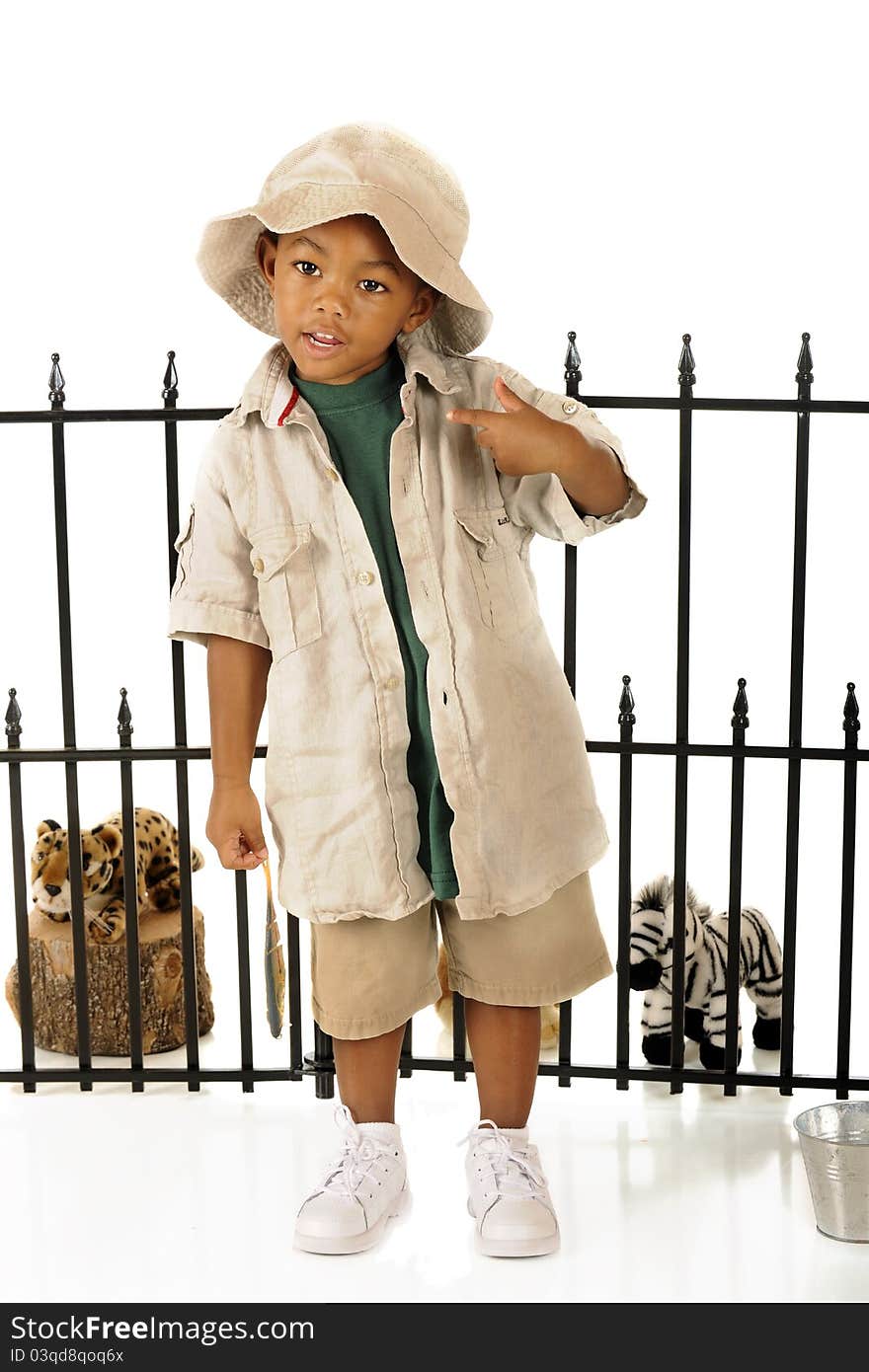 An adorable preschooler playing zookeeper with his toy animals. An adorable preschooler playing zookeeper with his toy animals.