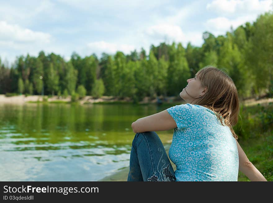 Young woman dreaming in summer nature