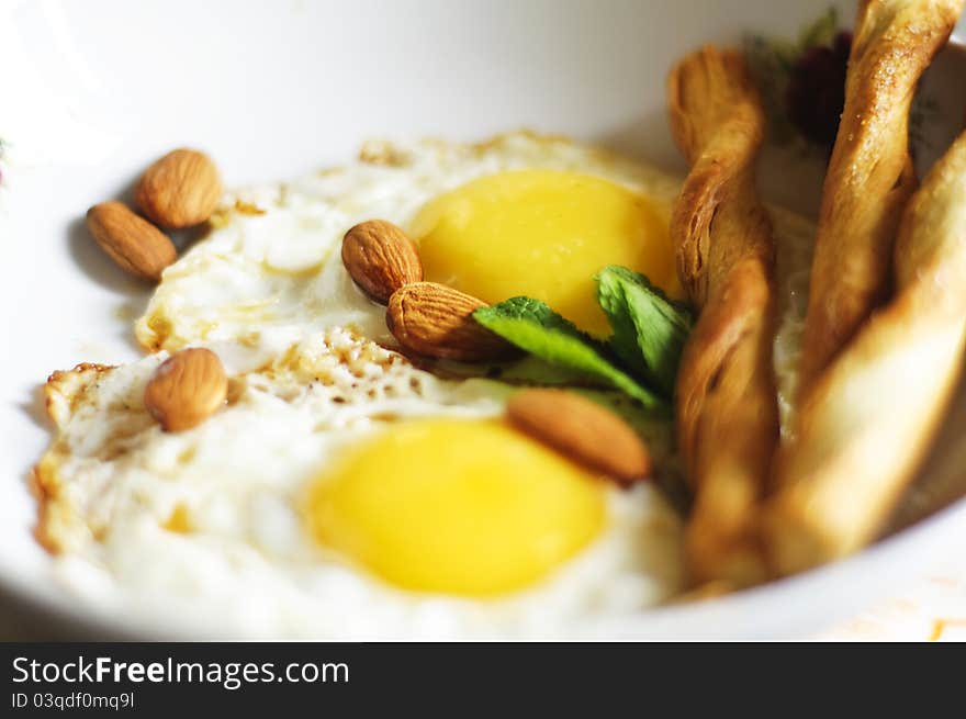 Fried eggs, almonds and salty crackers