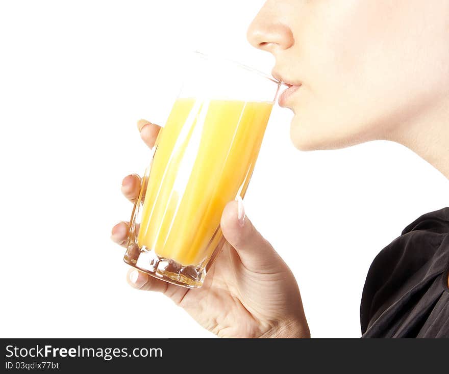 Young woman with a glass of juice in studio