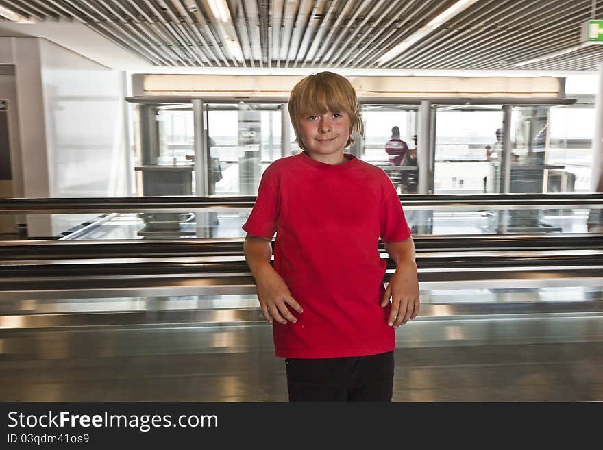 Boy on a moving staircase inside