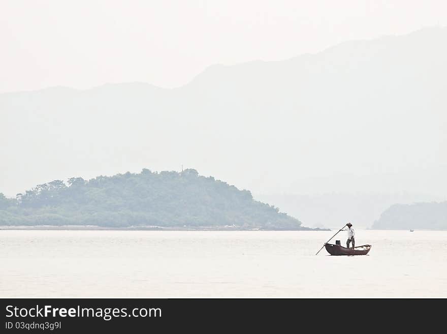 A Fisherman On Boat Alone In The Sea