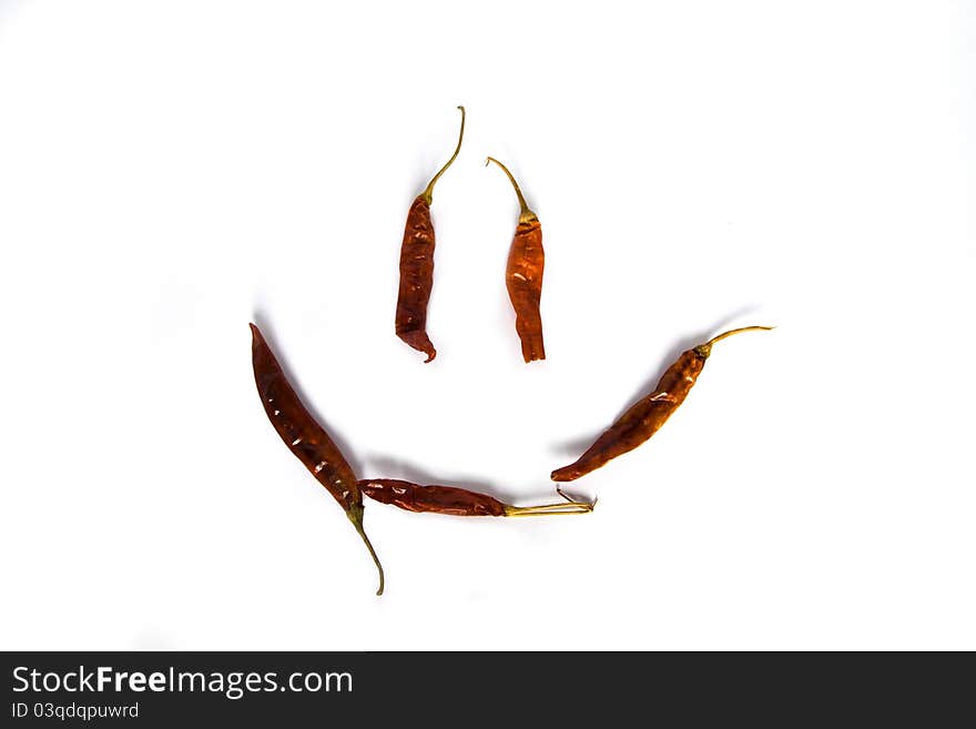 Red peppers laid out in a smile on a white background. Red peppers laid out in a smile on a white background