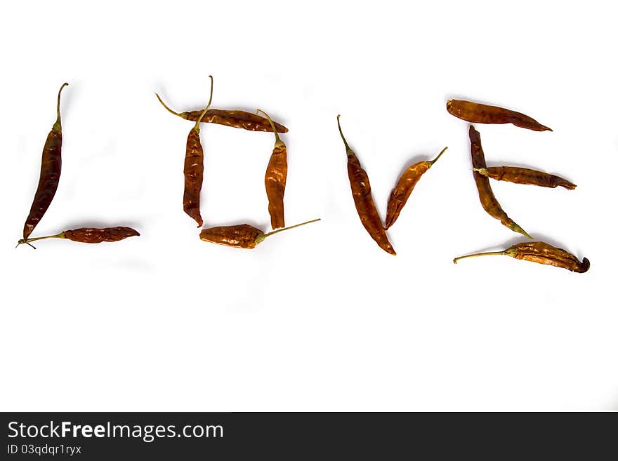 Red peppers laid out the word love on a white background. Red peppers laid out the word love on a white background