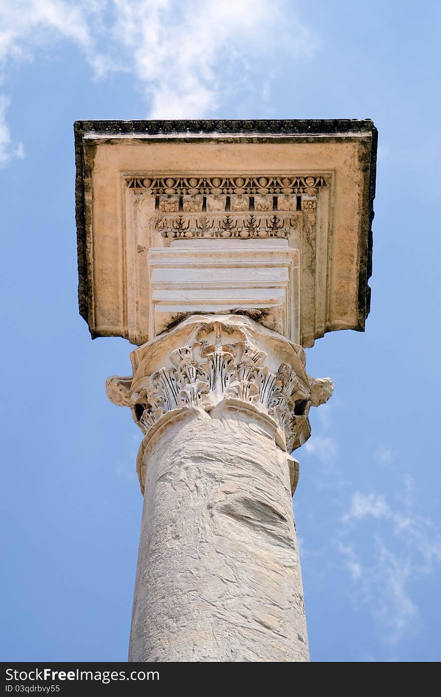 Ancient marble column against the blue sky. Rome, Italy