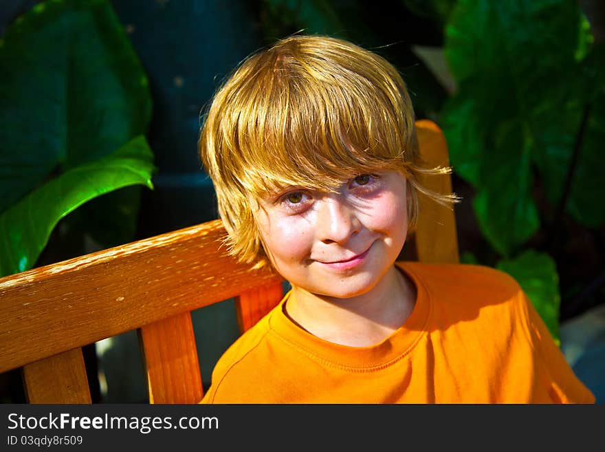 Boy relaxing on a bench