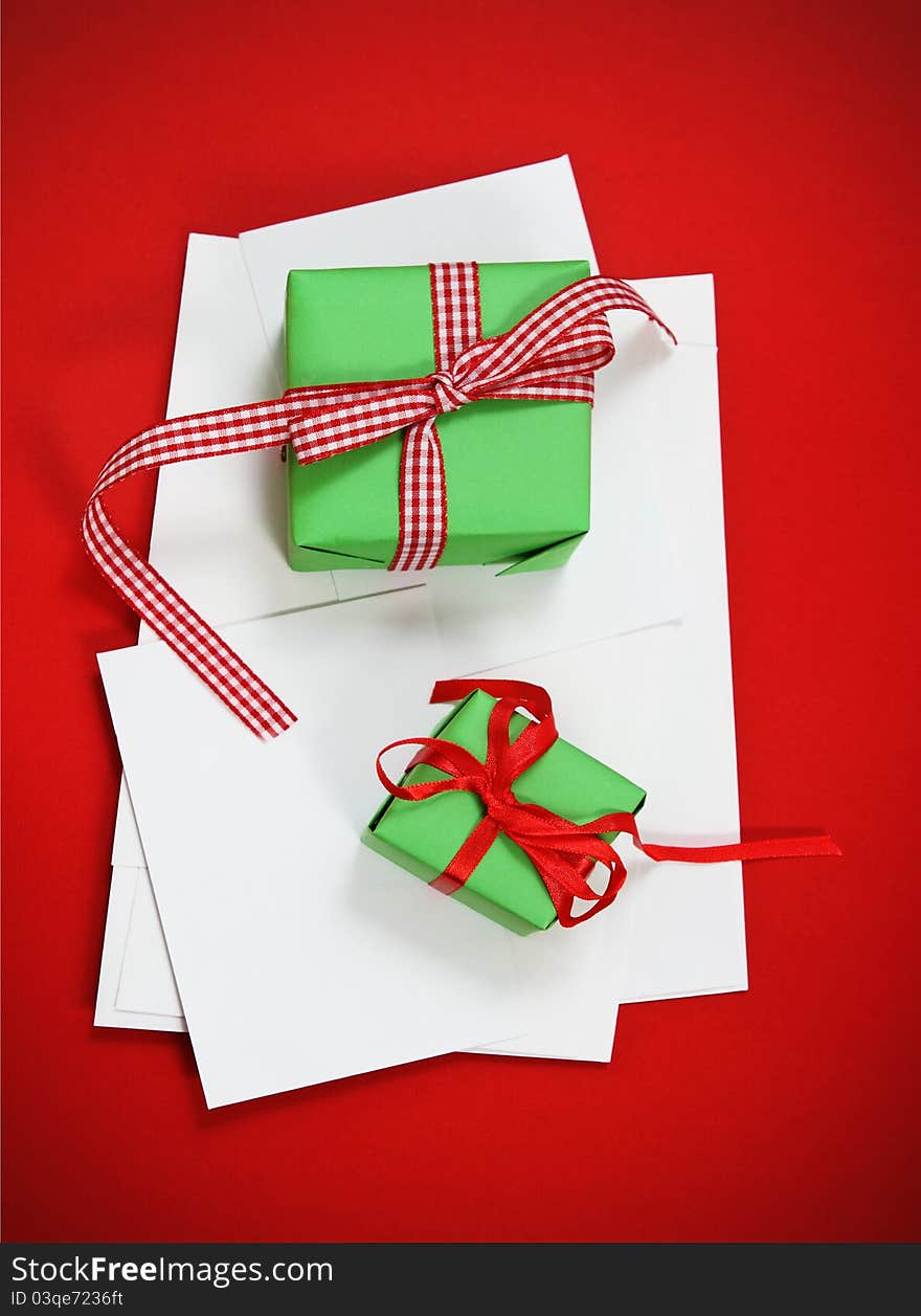 Christmas cards with Christmas presents on the red background. Paper with decorations and copy space