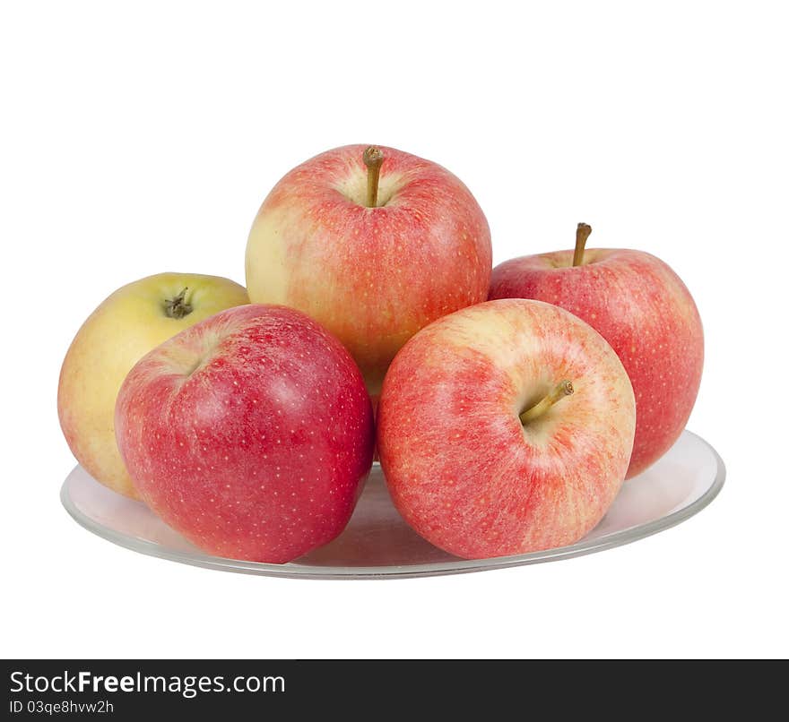 Red apples on a plate isolated on white background