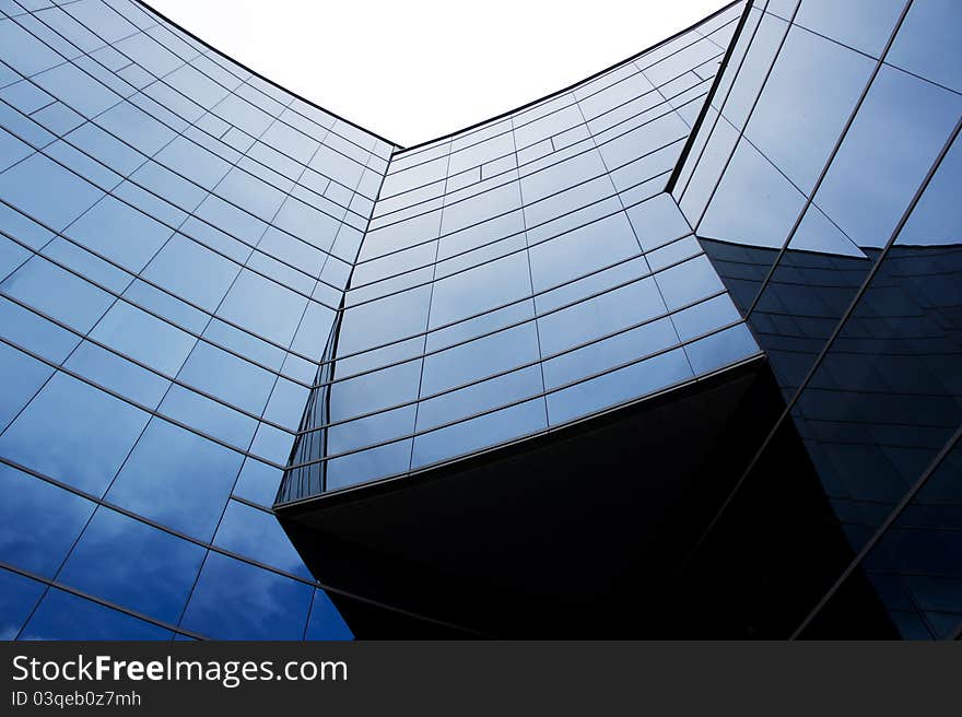 Three blue curve arc wall building structure against clear sky. Three blue curve arc wall building structure against clear sky.