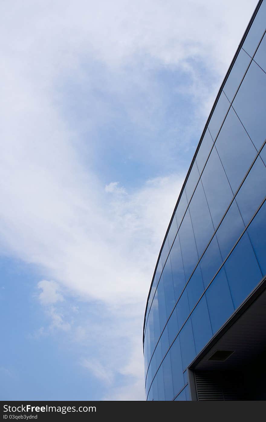 Blue Curve arc glass structure reflecting the clear sky. Blue Curve arc glass structure reflecting the clear sky